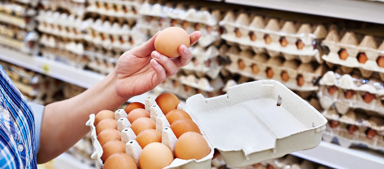 In the hands of a woman packing eggs in the supermarket