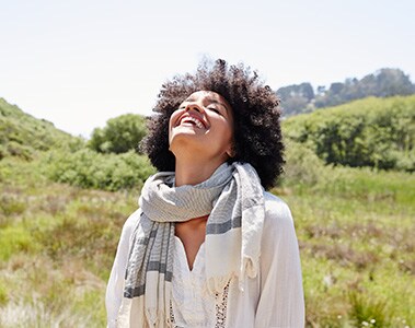 African American Woman Laughing Outside In Nature