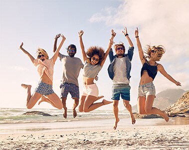 active young people jumping on a beach