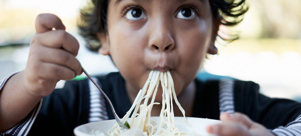 Little cute girl enjoy eating noodle at Street food market; Shutterstock ID 1745000681; purchase_order: -; job: -; client: -; other: -