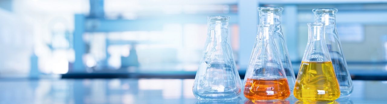 orange yellow solution in science glass flask win blue research chemistry laboratory banner background