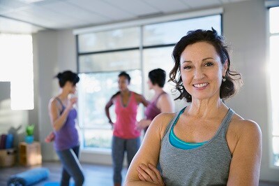 Portrait of smiling woman in yoga classroom