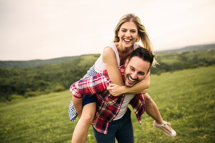 Romantic couple in love having fun outdoor at the empty field