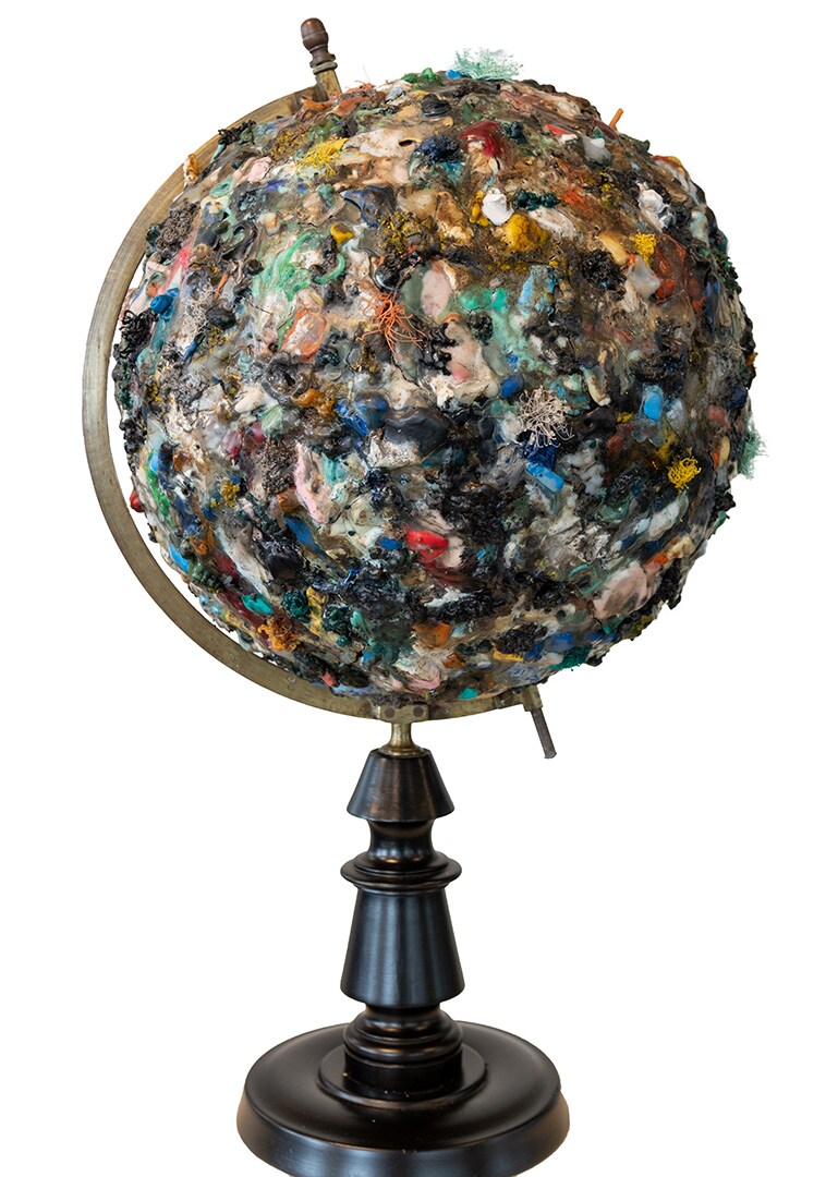 Continental Drift, Maarten van den Eynde (2017), vintage globe en gesmolten plastic uit de wereld oceanen, 40 x 40 x 100 cm