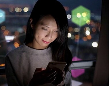 Foto de una mujer mirando la pantalla de un smartphone.