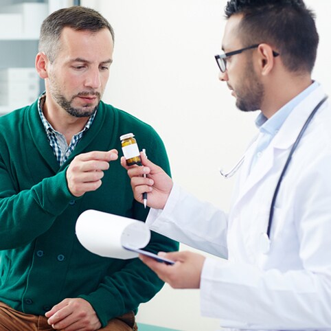 Doctor prescribing pills or vitamins to patient during medical consultation